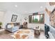 Bright living room featuring a large window with views of the surrounding forest at 509 Paiute Rd, Evergreen, CO 80439
