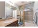 Well-maintained bathroom featuring a granite countertop, vanity, and tiled shower with glass doors at 2019 S Hannibal St # C, Aurora, CO 80013