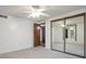 Bright bedroom with mirrored closet doors and neutral carpeting at 2019 S Hannibal St # C, Aurora, CO 80013