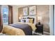 Bedroom with a queen bed, wood-paneled wall, and neutral decor at 11053 Snowdon St, Parker, CO 80134