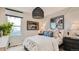Bedroom with a queen bed, white and blue decor, and wood-paneled wall at 11053 Snowdon St, Parker, CO 80134