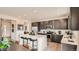 Modern kitchen with island, stainless steel appliances, and open floor plan at 11053 Snowdon St, Parker, CO 80134