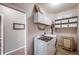 Functional laundry room with washer, dryer, shelving, and storage cabinets at 20790 Bridlewood Ln, Parker, CO 80138