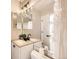 This bathroom has granite counters, double sinks, modern dark hardware, and great lighting at 8264 S Fillmore Way, Centennial, CO 80122