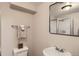 The cozy bathroom has a shower, sink, toilet, and mirror with towel rack at 8264 S Fillmore Way, Centennial, CO 80122