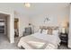 Bright bedroom with a decorative headboard, and carpeted floor with a view of the ensuite bathroom at 8264 S Fillmore Way, Centennial, CO 80122