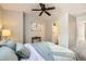 Serene bedroom featuring a decorative ceiling fan, carpeted floor and ensuite bathroom at 8264 S Fillmore Way, Centennial, CO 80122