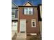 Two-story townhouse featuring brown siding, white trim, security door, and a covered porch at 8264 S Fillmore Way, Centennial, CO 80122