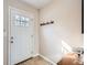 Foyer with tile floor, coat rack, and white front door at 8264 S Fillmore Way, Centennial, CO 80122