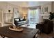 View of the living room with a fireplace and access to the balcony from the dining room at 8264 S Fillmore Way, Centennial, CO 80122