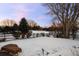 Snowy backyard with a view of a house in the distance at 7172 Waterford Ct, Niwot, CO 80503