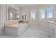 Spa-like bathroom with soaking tub, double vanity, and large mirrors at 7172 Waterford Ct, Niwot, CO 80503