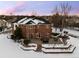 Back exterior of the house with a patio and snowy landscape at 7172 Waterford Ct, Niwot, CO 80503