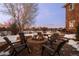 Brick fire pit with seating in a snow covered backyard at 7172 Waterford Ct, Niwot, CO 80503