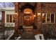 Elegant entryway with a wood door and brick columns at 7172 Waterford Ct, Niwot, CO 80503