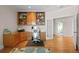 Home office with built-in shelves, wood desk, and hardwood floors at 7172 Waterford Ct, Niwot, CO 80503