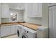 Bright laundry room with white cabinets, ample counter space, and washer/dryer at 7172 Waterford Ct, Niwot, CO 80503