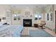 Main bedroom with fireplace, built-in shelving and large windows at 7172 Waterford Ct, Niwot, CO 80503