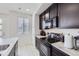 Modern kitchen with dark cabinetry and stainless steel appliances at 9643 Truckee St, Commerce City, CO 80022