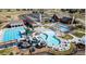 Aerial view of the community pool complex with multiple pools, waterslides, and lounge areas at 3111 Youngheart Way, Castle Rock, CO 80109