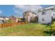 Expansive backyard with lush green grass and wood fence, ideal for outdoor activities and relaxation at 3111 Youngheart Way, Castle Rock, CO 80109