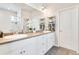 Bathroom featuring double sinks, granite countertops, and neutral wall paint at 3111 Youngheart Way, Castle Rock, CO 80109