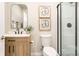Modern bathroom with wood vanity, vessel sink, toilet, and glass-enclosed shower at 3111 Youngheart Way, Castle Rock, CO 80109