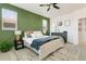 Spacious bedroom featuring a decorative green accent wall and plenty of natural light at 3111 Youngheart Way, Castle Rock, CO 80109