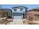 Charming two-story home featuring a gray garage door, stone accents and well-kept landscaping at 3111 Youngheart Way, Castle Rock, CO 80109