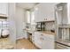 Bright kitchen features granite countertops, white cabinetry, and a stainless steel refrigerator at 3111 Youngheart Way, Castle Rock, CO 80109