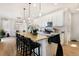 Open kitchen with island, stainless steel appliances, and view of dining and living areas at 3111 Youngheart Way, Castle Rock, CO 80109
