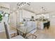 Bright kitchen with white cabinets, an island with seating and stainless steel appliances at 3111 Youngheart Way, Castle Rock, CO 80109