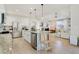 Spacious kitchen with an island and an open view of the living room and dining room at 3111 Youngheart Way, Castle Rock, CO 80109