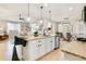 Open layout features a granite countertop island with a sink, stainless appliances, and bar stool seating at 3111 Youngheart Way, Castle Rock, CO 80109