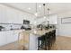 Modern kitchen with granite countertops and a large island with barstool seating at 3111 Youngheart Way, Castle Rock, CO 80109