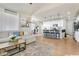 Open-concept layout shows living room and kitchen with breakfast bar seating at 3111 Youngheart Way, Castle Rock, CO 80109