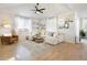 Bright living room features a comfy white sectional, modern decor, and beautiful natural light at 3111 Youngheart Way, Castle Rock, CO 80109