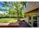 A spacious backyard features a wood deck and a well-maintained lawn with beautiful trees at 19706 E Bellewood Dr, Centennial, CO 80015
