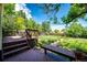 Backyard deck with wood bench and stairs offers a beautiful outdoor living space at 19706 E Bellewood Dr, Centennial, CO 80015