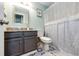 A bathroom with light green walls, patterned tile floor, and a granite countertop vanity at 19706 E Bellewood Dr, Centennial, CO 80015