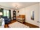 Cozy Bedroom room features wood floors, a window, a crib and a sitting chair at 19706 E Bellewood Dr, Centennial, CO 80015