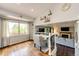 Bright dining area with hardwood floors and large window, seamlessly connecting to the living room at 19706 E Bellewood Dr, Centennial, CO 80015
