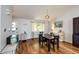Charming dining room with hardwood floors, piano, and plentiful natural light creating a cozy space at 19706 E Bellewood Dr, Centennial, CO 80015