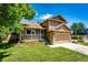 A charming two-story home featuring stone accents, a well-manicured lawn, and a cozy front porch at 19706 E Bellewood Dr, Centennial, CO 80015
