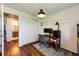 This home office features wood floors, a computer, and a view to the hall bathroom at 19706 E Bellewood Dr, Centennial, CO 80015