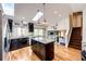 Granite island is shown in this modern kitchen with ample light and skylights with an open floorplan at 19706 E Bellewood Dr, Centennial, CO 80015