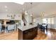 Kitchen island view showcasing open floorplan with skylights, and stairs at 19706 E Bellewood Dr, Centennial, CO 80015