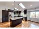 Well-lit kitchen boasts stainless appliances, a center island, and light-filled skylights overhead at 19706 E Bellewood Dr, Centennial, CO 80015