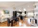 Bright, open floor plan showcasing the kitchen, dining area, and hardwood floors with vaulted ceilings at 19706 E Bellewood Dr, Centennial, CO 80015