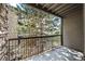 Outdoor balcony view, with large tree and exterior brick building at 2575 S Syracuse Way # H206, Denver, CO 80231